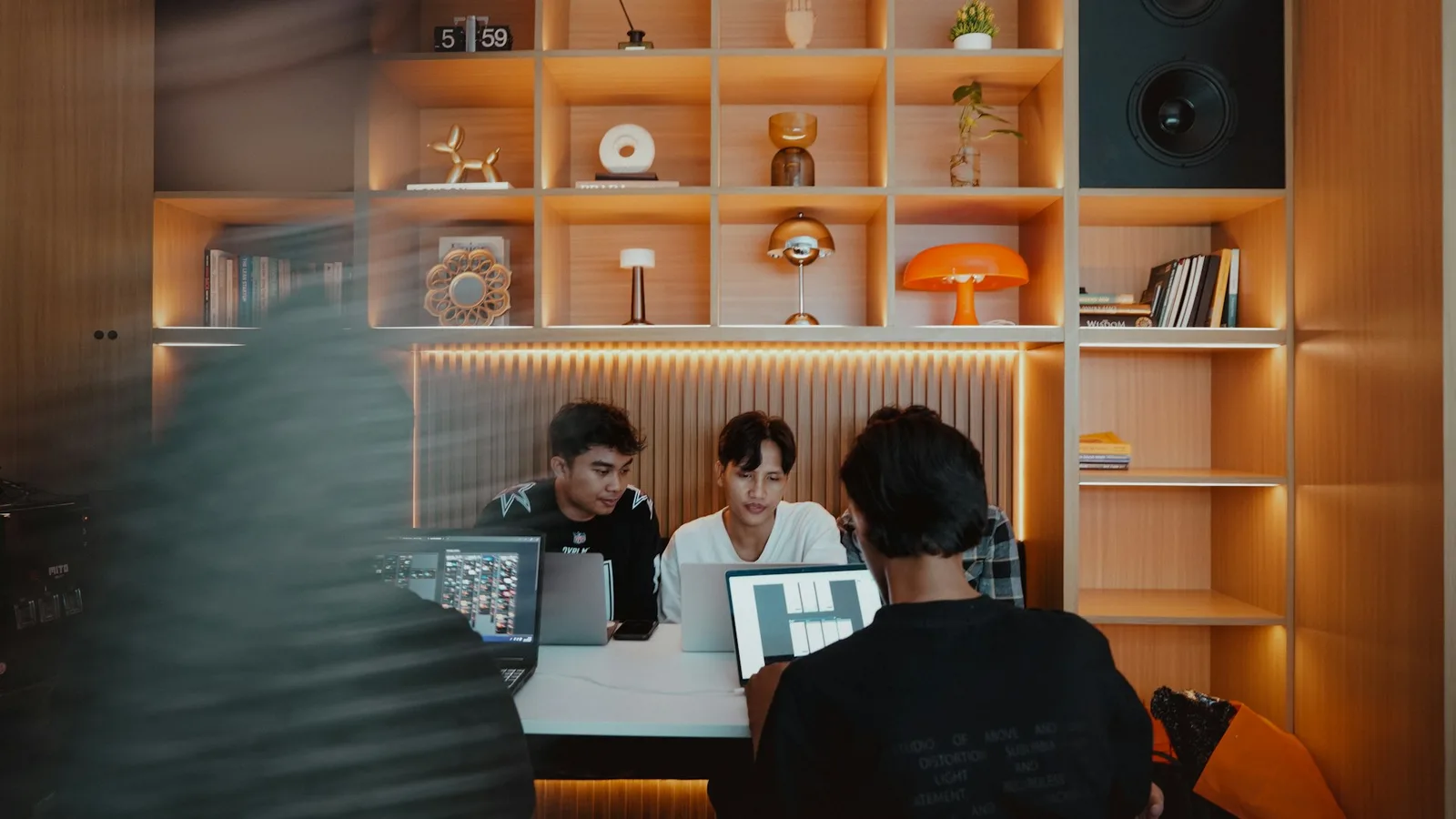 A small product team reviewing work together around a table